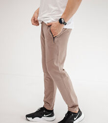 Спортивні штани на манжетах, кишені на застібках